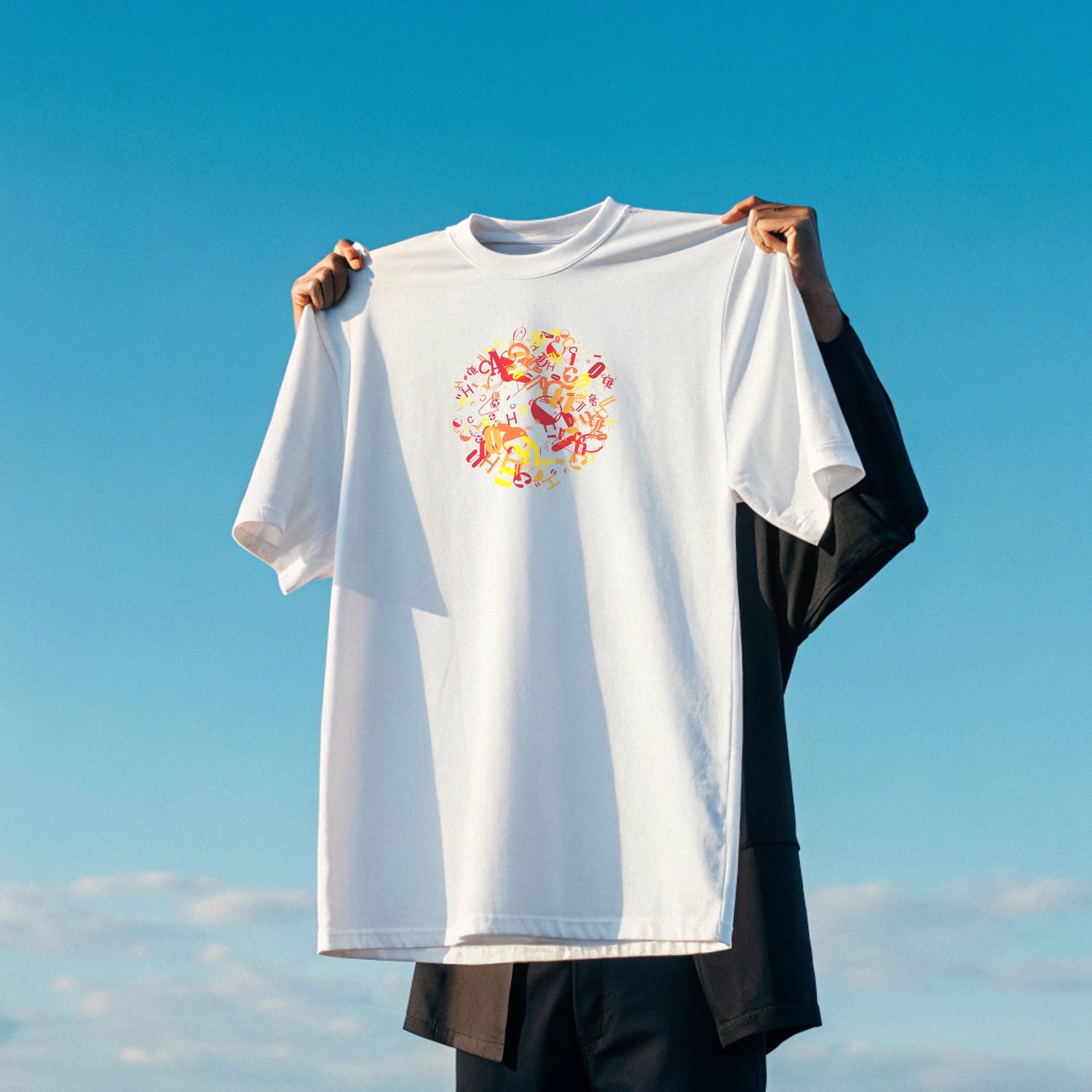 Creating Adam's the chaos tee held up in hands